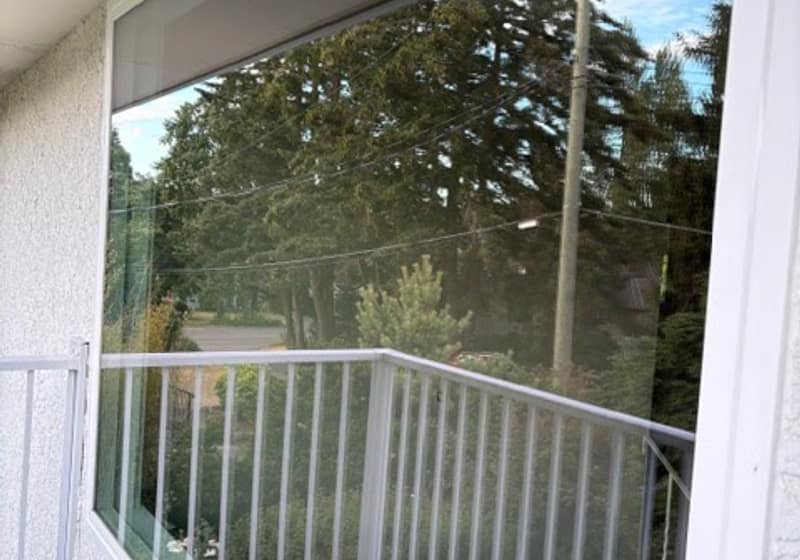 Clean glass windows and railing on a Victoria home after window cleaning